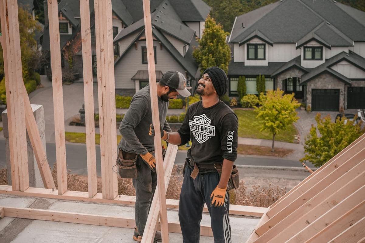 Construction workers installing wall frames