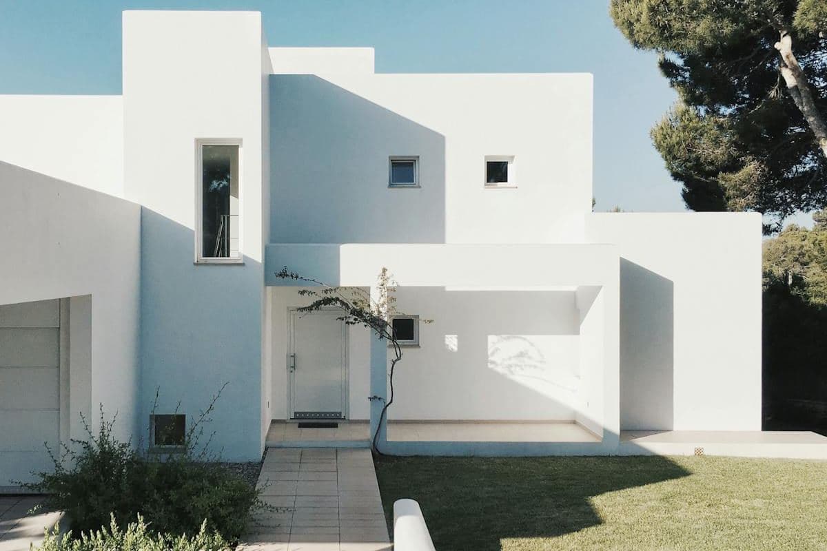 Custom home with north-facing courtyard and clean white facade