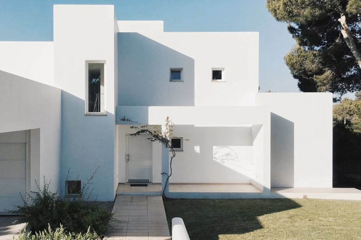 Custom home with north-facing courtyard and clean white facade