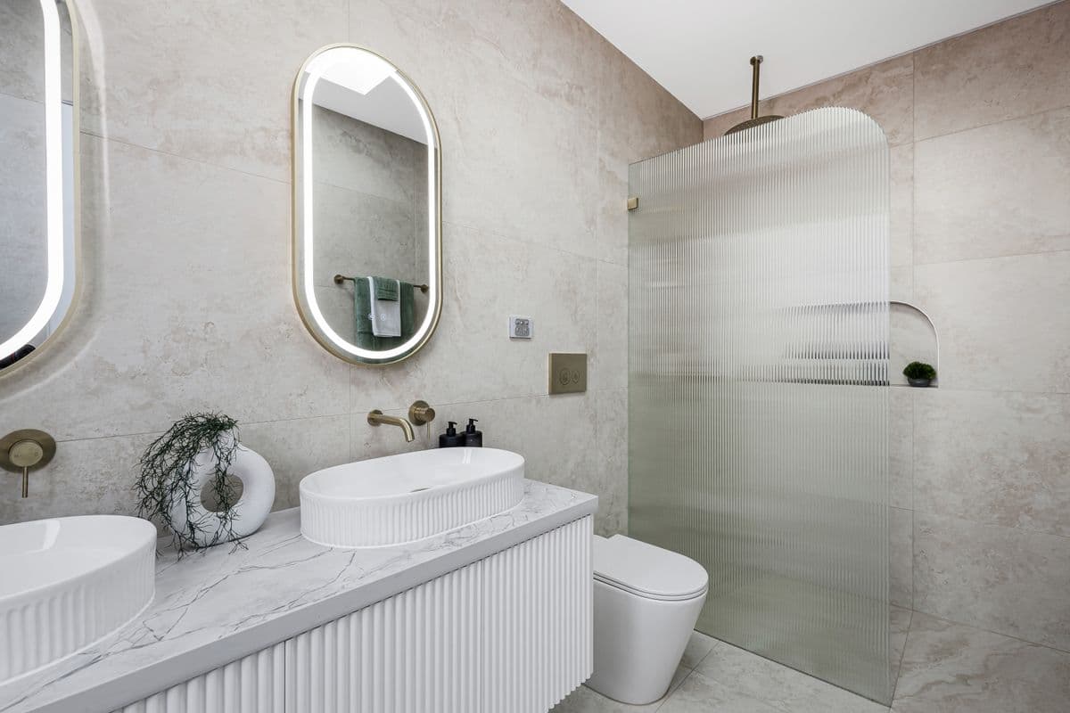 Ensuite bathroom in Buildana duplex — floor to ceiling tiles