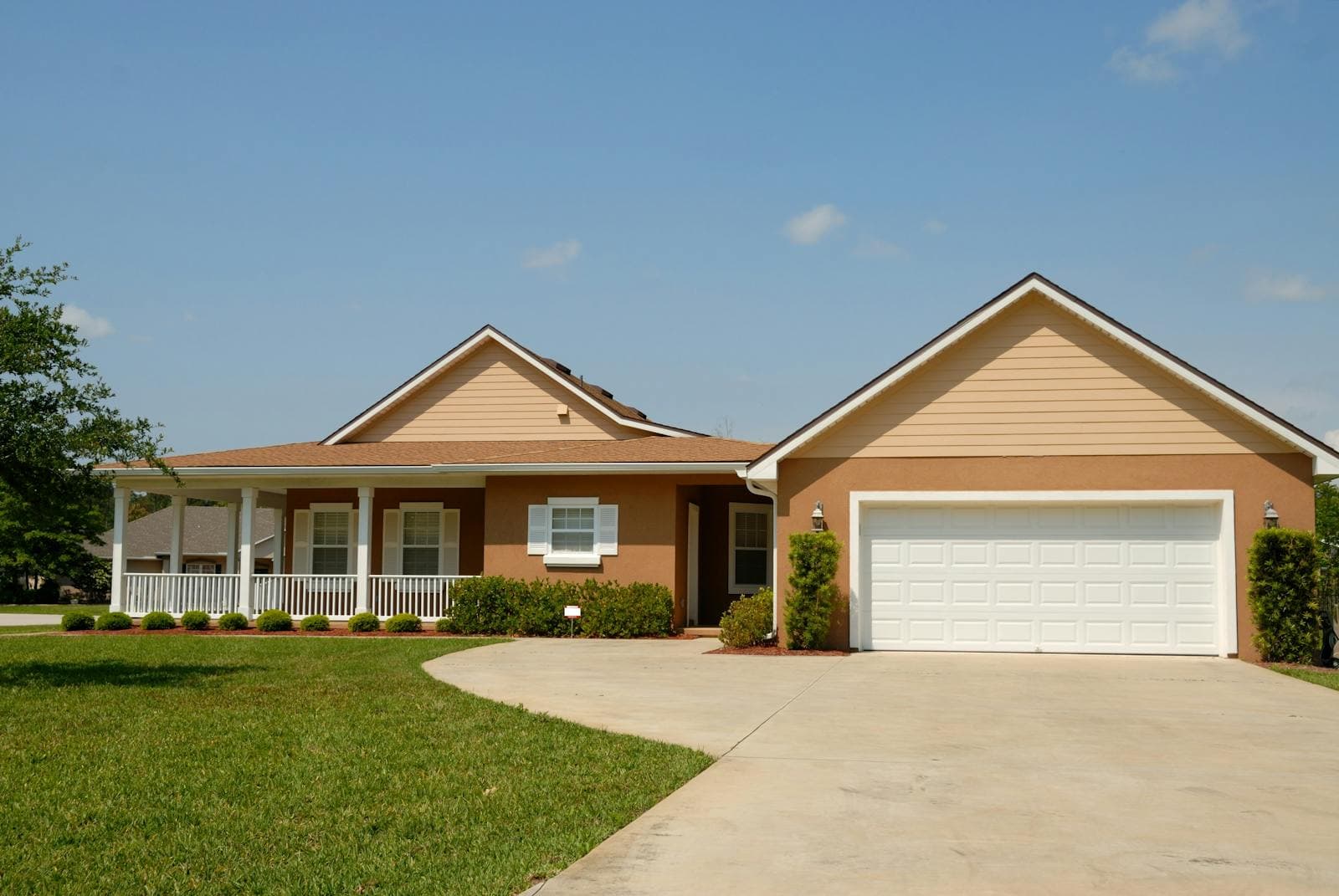 Single-storey brick home with a double garage set back on a wide green lawn