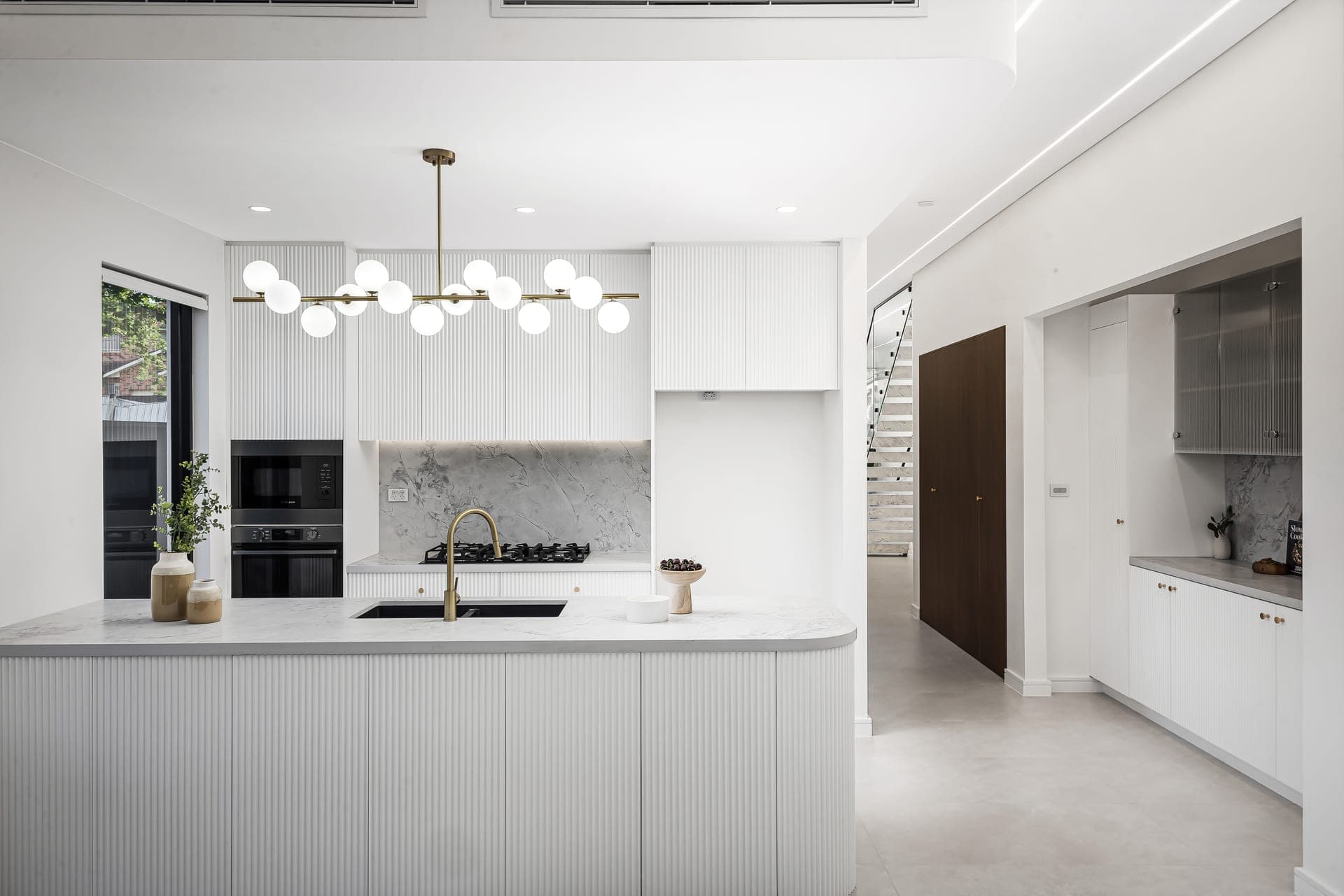 Kitchen and living renovation with island bench and butler's pantry