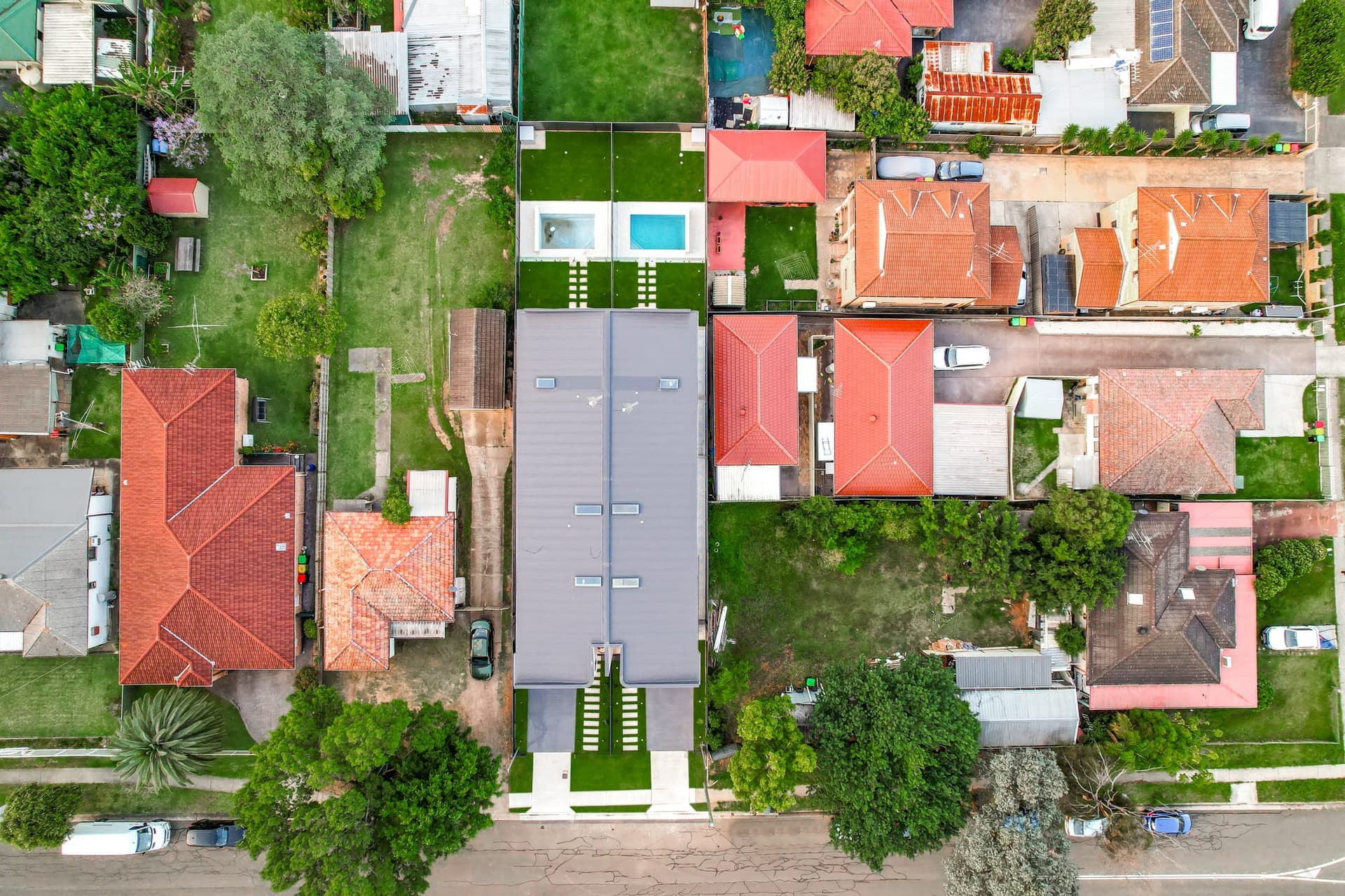 Looking down on a newly built duplex surrounded by post-war cottages