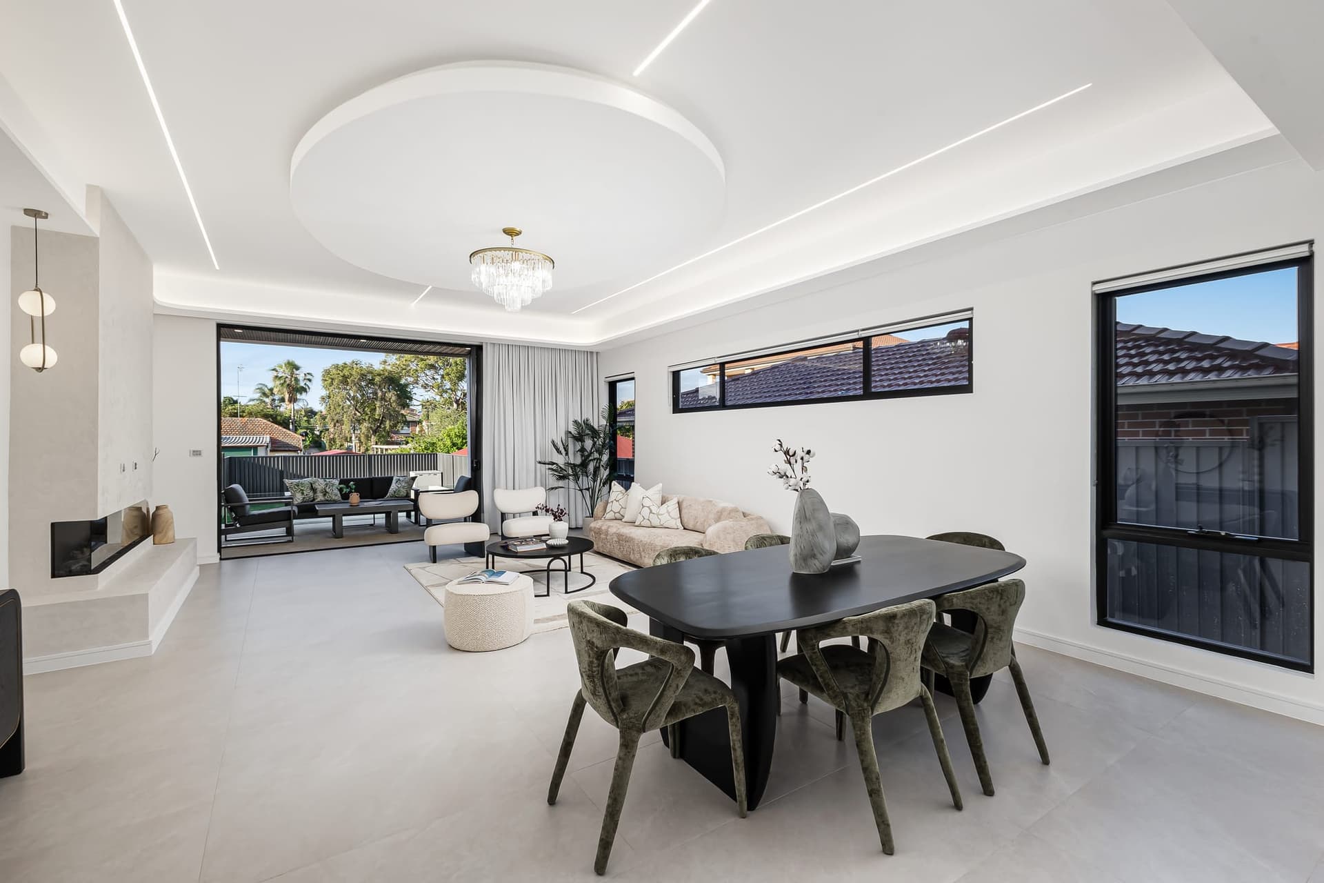 Open-plan living and dining with timber floors and large sliding doors