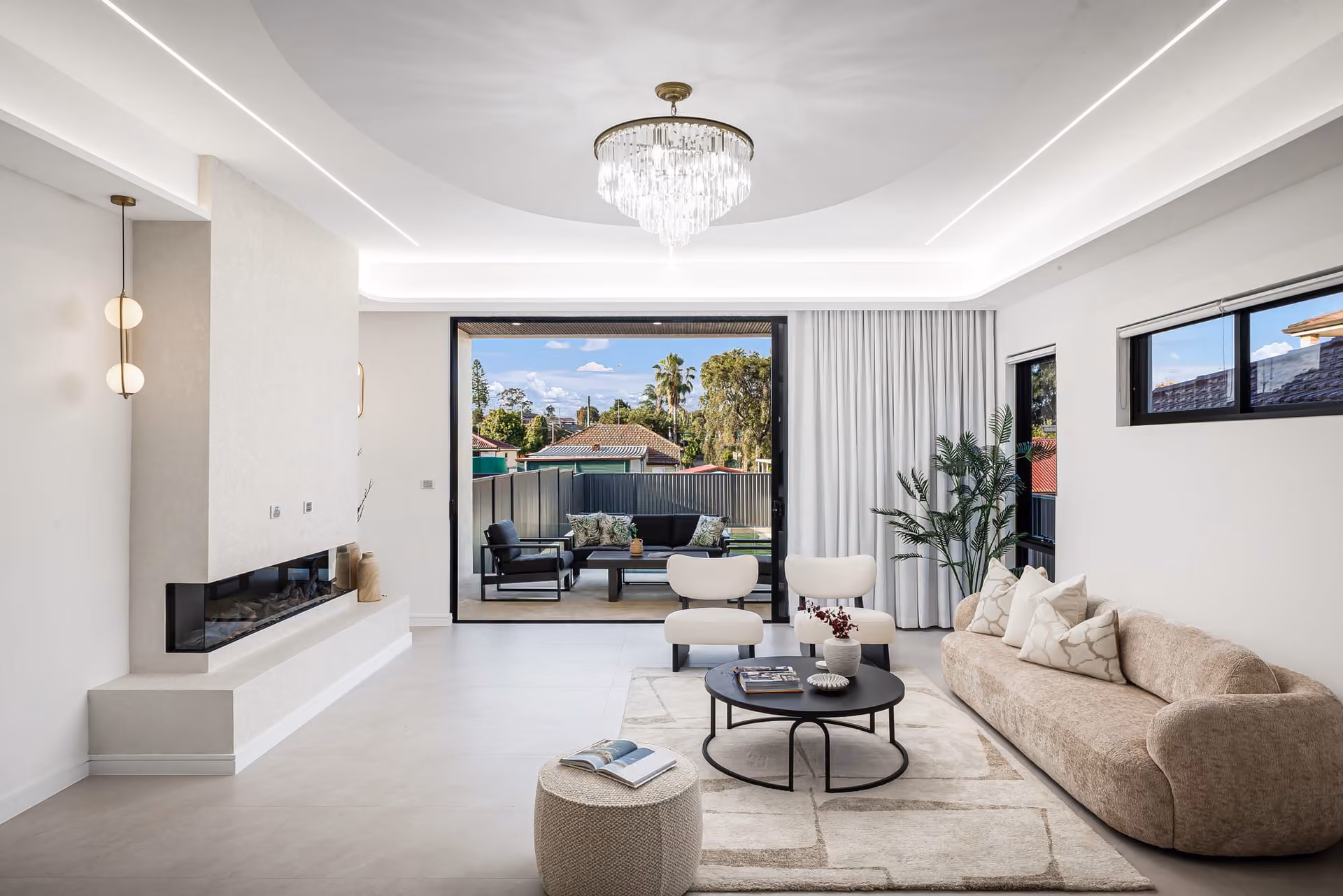 Living room with a fireplace wall and joinery, separated from the kitchen