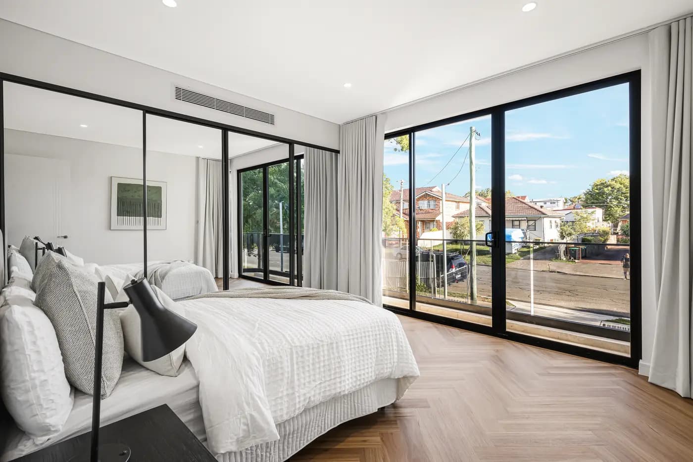 Duplex master bedroom with herringbone timber floor